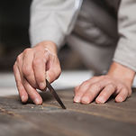 a piece of wood being hand carved by Masterpiece Lasered Wood Ltd. 
