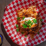 Fresh Homemade Perogie's topped with sour cream and green onion at Perogie Palace