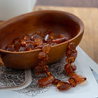 Amber Jewelry in a wood bowl at Jewel of the Sea