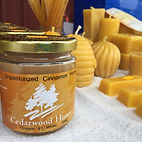 A selection of Honey and Bee broducts including candles, honeysticks, and cinnamon honey from Cedarwood Honey