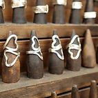 Sterling silver rings displayed on a wood display at Miluz Art