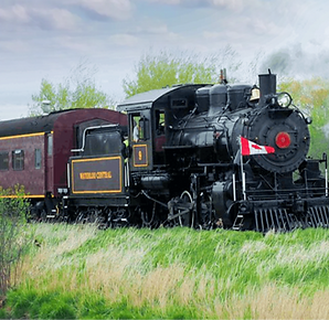 Heritage train travelling across the countryside. Text Overlay reads "Waterloo Central Railway"